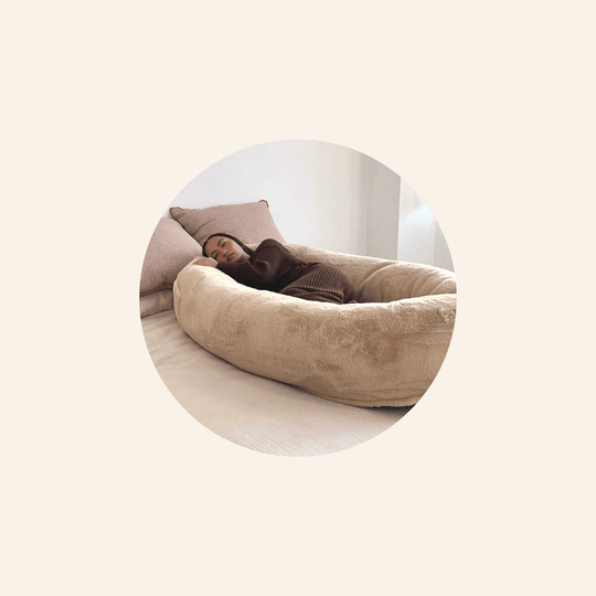 Girl Sleeping on the Plufl Human Dog Bed on Top of Her Bed