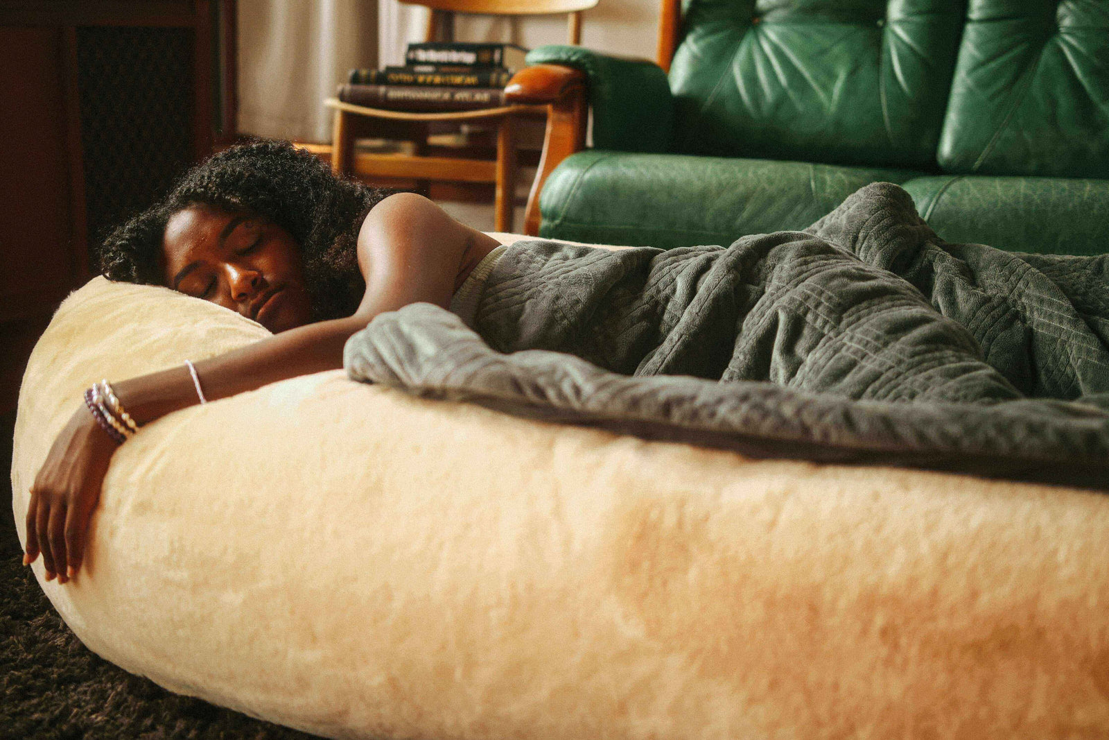 Woman comfortably sleeping in the Plufl: The World's First Dog Bed for Humans