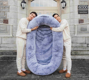 Founders of Plufl hugging the world's first human dog bed