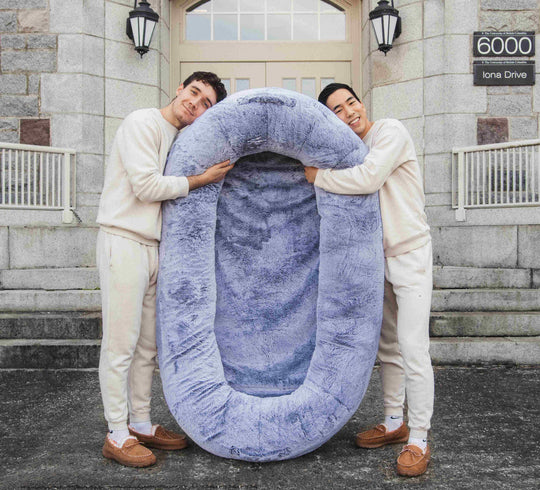 Founders of Plufl hugging the world's first human dog bed
